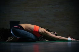 Fitness woman in stretching pose for RehabilitativeTherapy.com